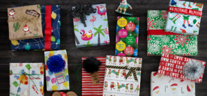 A collection of Charleston Wrap gift wrapping supplies, featuring festive Christmas wrapping paper and decorative accessories.