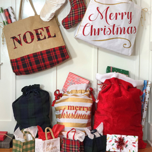 An assortment of bags featuring different holiday sayings