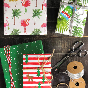 Presents wrapped in flamingo, leaves, and tree wrapping paper