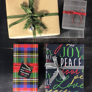 An assortment of gifts wrapped in peace love joy wrapping paper