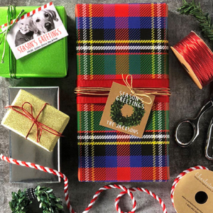 A gifts wrapped in plaid wrapping paper and glitter wrapping paper