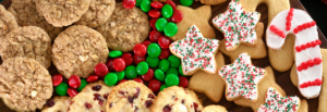 A festive tray displaying an assortment of cookies alongside colorful candy canes, perfect for holiday celebrations.