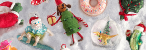 A variety of colorful Christmas ornaments arranged neatly on a white surface, showcasing festive designs and textures.