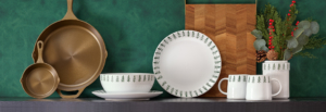A green wall serves as a backdrop for a green table set with white plates, creating a harmonious and fresh dining atmosphere.
