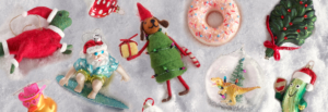 A variety of colorful Christmas ornaments arranged neatly on a white surface, showcasing festive designs and textures.