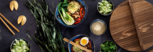 A table set with various bowls of food accompanied by chopsticks, inviting a communal dining experience.