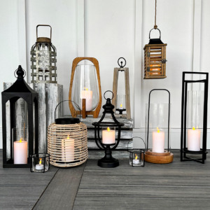 A diverse collection of lanterns and candles, showcasing various designs and colors, illuminating a cozy setting.